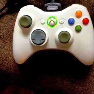 White Xbox360 Controller and Comes with charger .